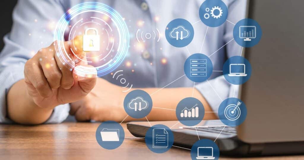 Person sat at a laptop pressing holographic lock to symbolise securing their business from cyber security threats